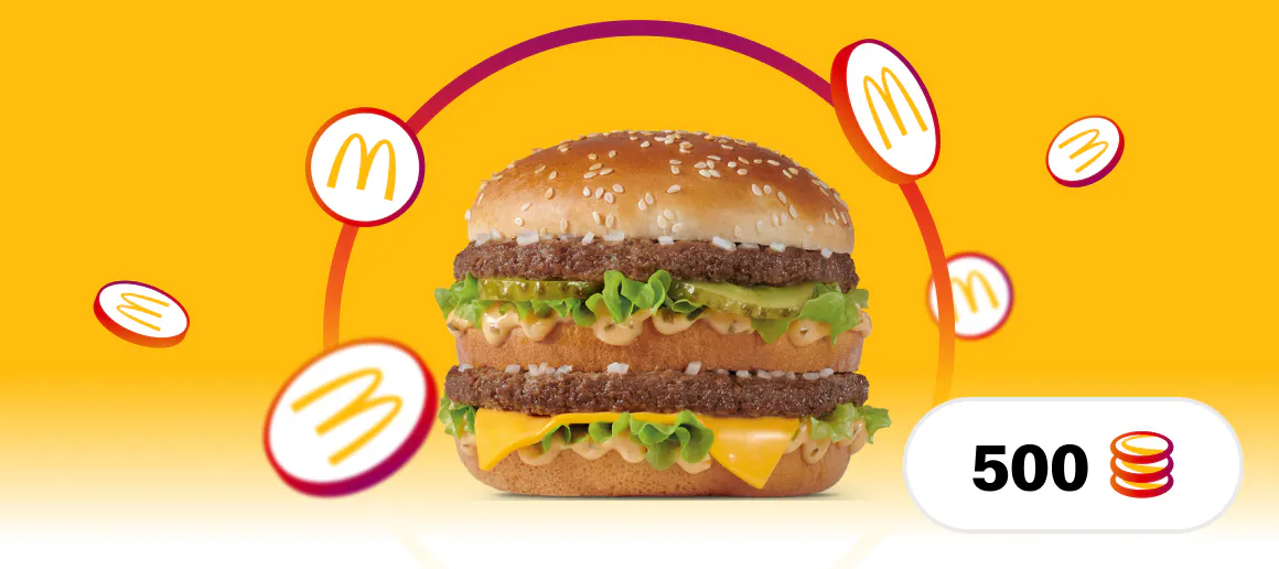 Hamburguesa Big Mac sobre un fondo amarillo y donde caen alrededor monedas con el logo de McDonalds, abajo a la derecha hay un espacio con un texto que indica que son 500 puntos.