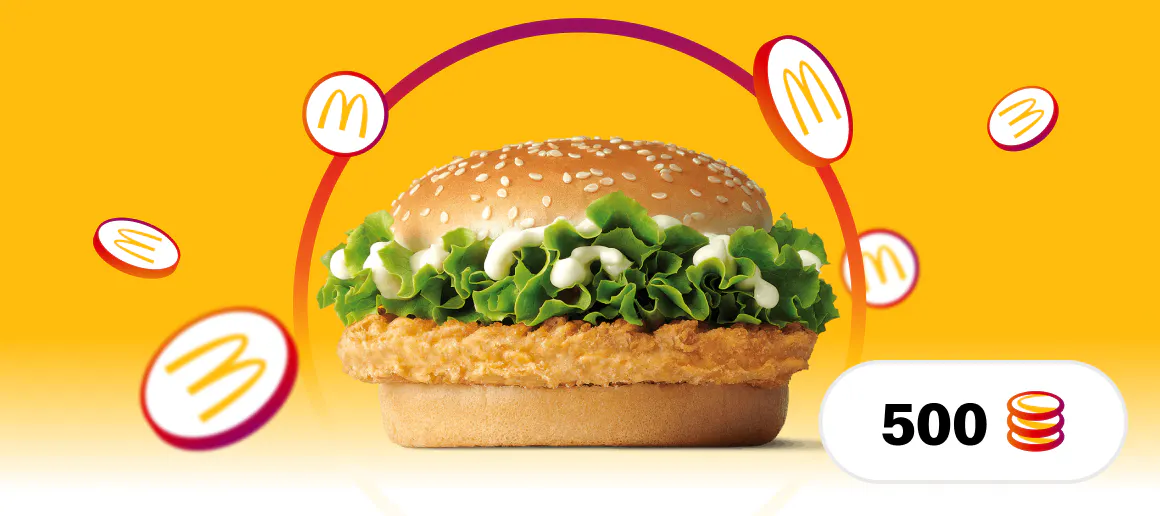 Hondo horian kokatutako McDonalds McPollo hanburgesa baten irudia, inguruan MyMcDonalds logotipoa duten txanponak eta beheko eskuinaldean 500 zenbakia eta txanponaren ikonoa dituen ikono batekin.